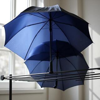 Umbrellas open on a drying rack